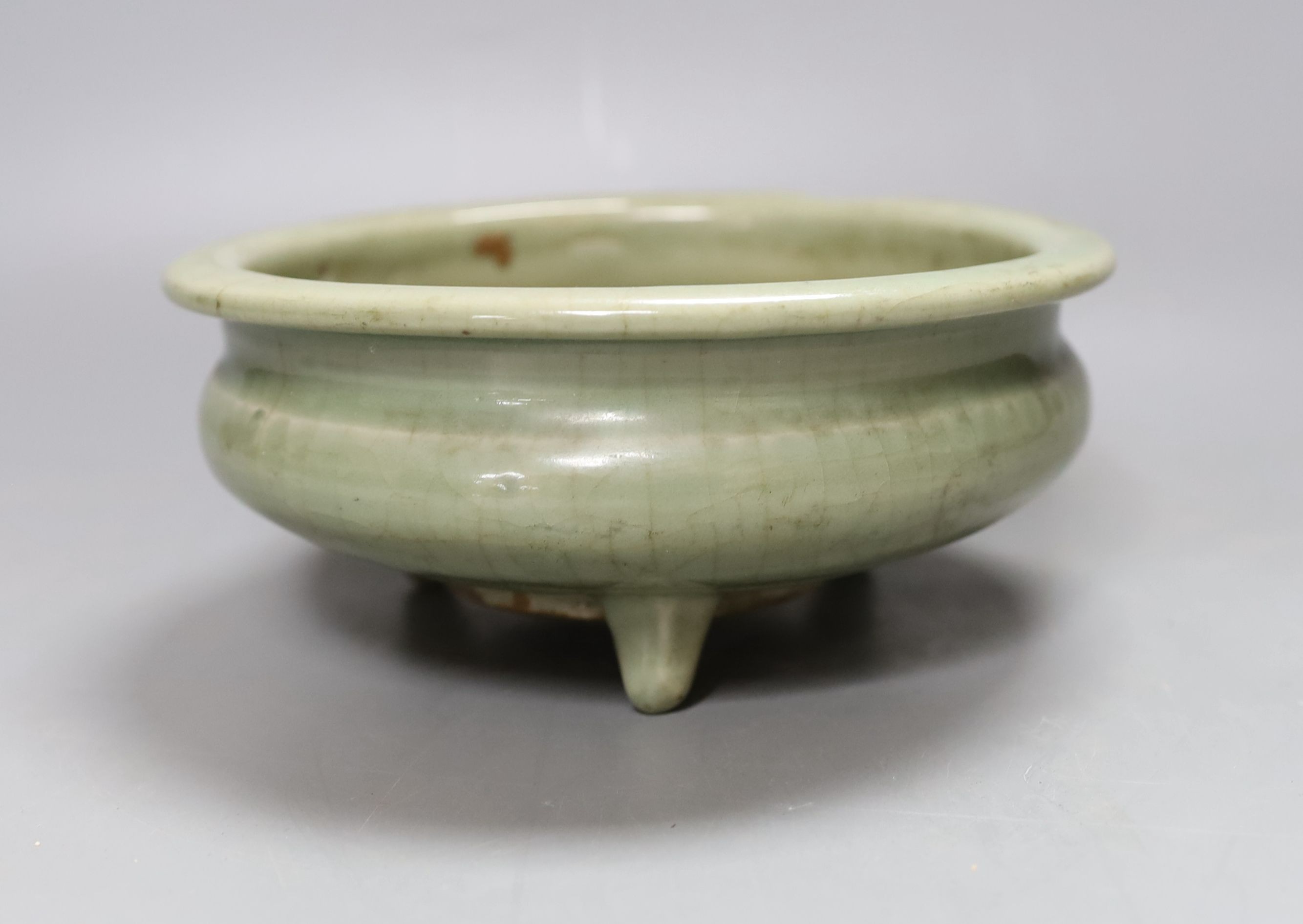 A Chinese Ming Longquan celadon tripod censer, 14th/15th century - 8cm tall